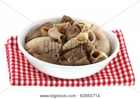 A bowl of Fresh Chitterlings (Pork intestines) and other Entrails on a Checkered table cloth, isolated on a white background