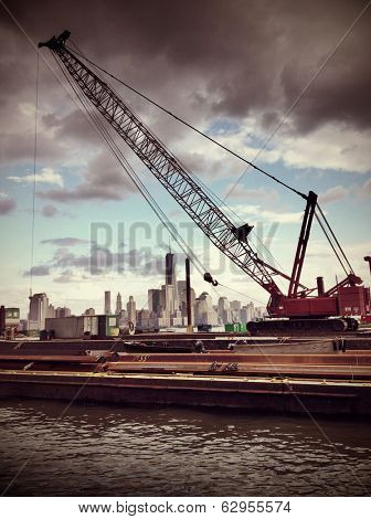 Instagram style image of a crane with lower Manhattan skyline in background