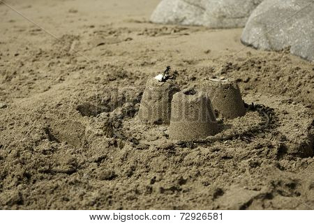 Three Simple Sandcastles on Beach