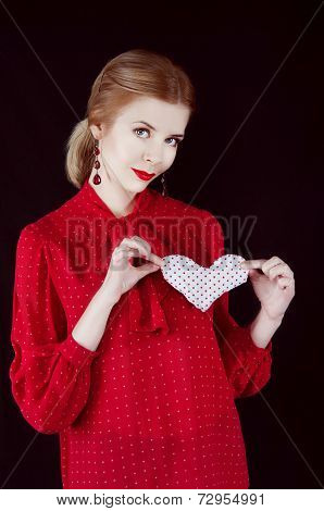 Beautiful young blonde woman with fabric heart