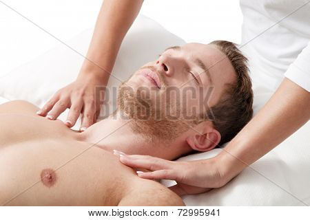 Relaxed eyes closed man getting massage