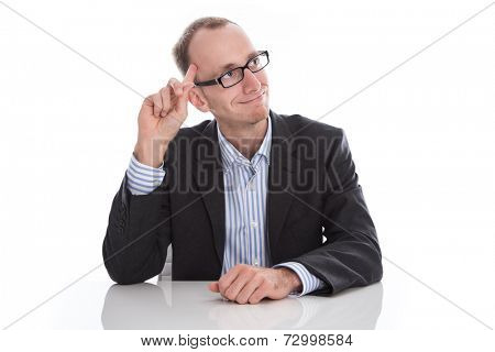 Clever businessman sitting at desk with new idea in mind isolated on white background