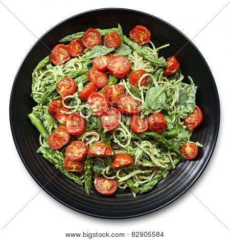 Spaghetti with roasted tomatoes, spinach, and asparagus pesto.  Overhead view food background.