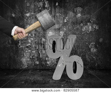 Hand Holding Sledgehammer Hitting Cracked Percentage Sign With Dark Room