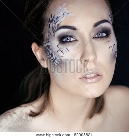 fashion portrait of pretty young woman with creative makeup like