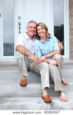 Senior couple at new home. Retirement security concept.