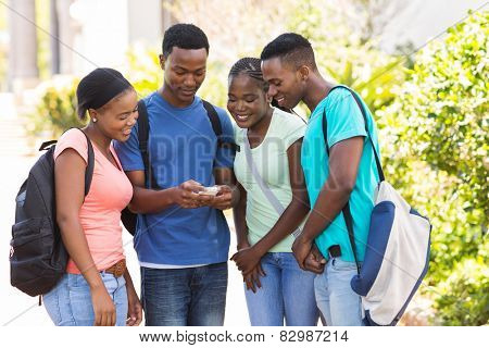 group of cute african american college students using cell phone on campus