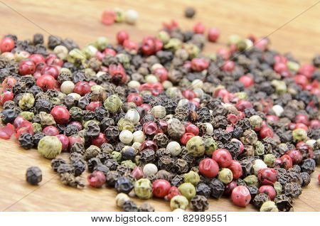 pepper sprinkled on raw wood.