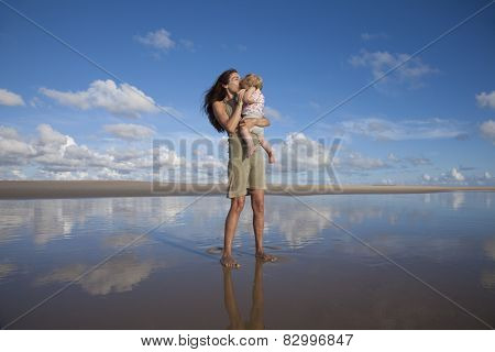 Woman Kisses Baby At Reflect Beach