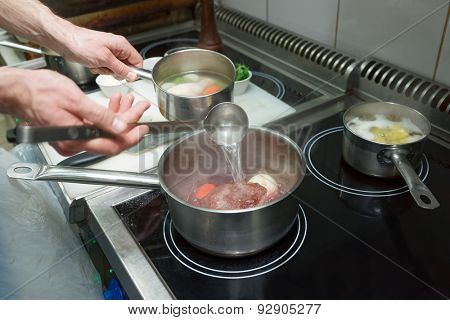 Chef is cooking ox tail, professional kitchen