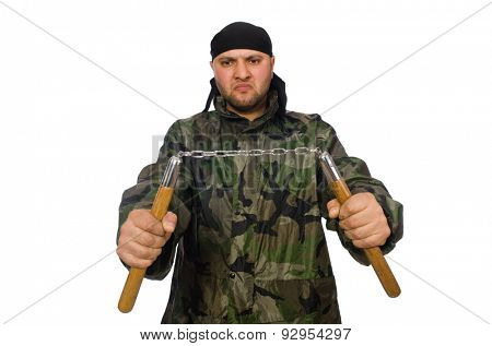 Young man in soldier uniform holding nunchaks isolated on white