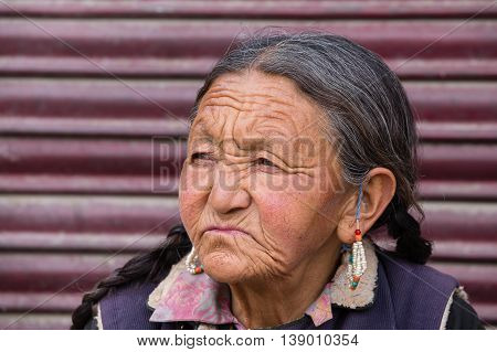 LEH INDIA - JUNE 21 2015: Unidentified beggar woman on the street in Leh Ladakh. Poverty is a major issue in India