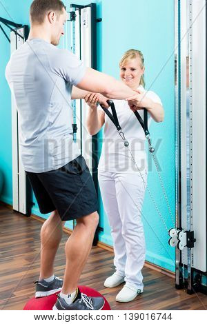 Patient at the physiotherapy doing physical exercises with Bowden cable 