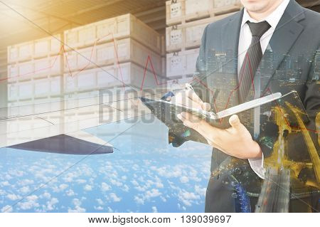Double Exposure Of Businessman Checking Report And Business Center City With Blurred Cargo In Wooden