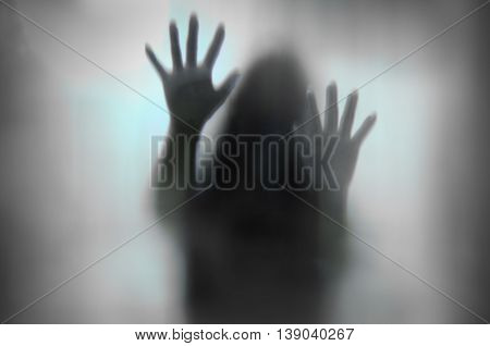 Horror Woman Behind The Matte Glass In Black And White. Blurry Hand And Body Figure Abstraction.