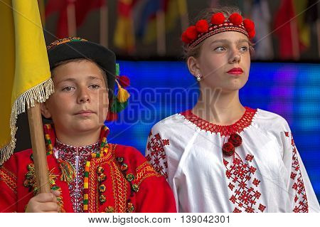 ROMANIA TIMISOARA - JULY 92016:Young Ukrainian in traditional costume with national flag present at the folk festival "International Festival of hearts" organized by the City Hall Timisoara.