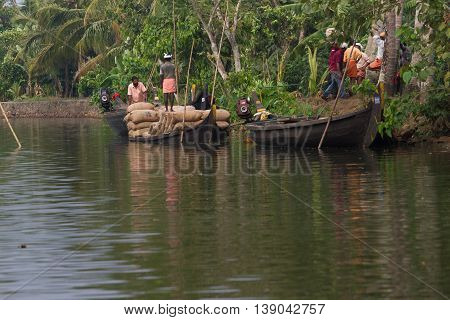 Allepey, Kerala, India - March 31, 2015: Some men transport, overload, put on them head bag of rice