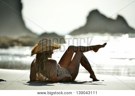 young woman relaxing on the beach in summer day