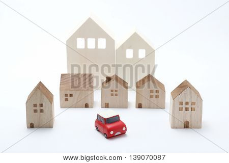 Miniature car and houses on white back ground.
Car sharing concept.