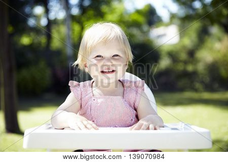 Baby Waiting For Lunch In A Garden