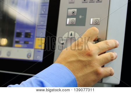 Operator controls the modern computer equipment. Selective focus on hand.