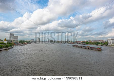 Tugboat towing freighter in Chao Praya River - Bangkok Thailand
