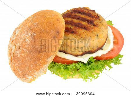 Chicken burger with salad and mayonnaise in a crusty bread roll isolated on a white background