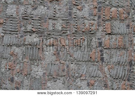 destroyed red brick wall showing mortar and bricks