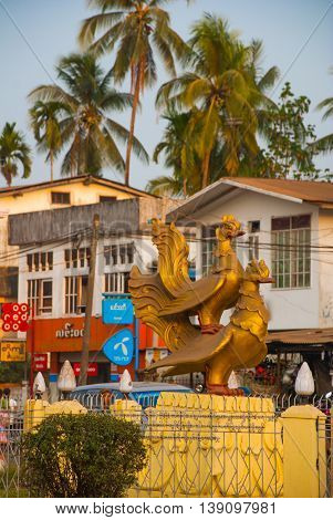 Two Gold Sculptures Of Birds. One Bird Sits On The Other. Bago In Myanmar. Burma.