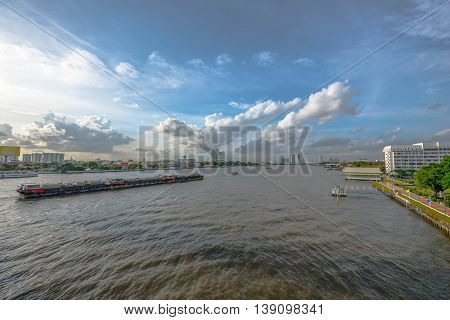 Tugboat towing freighter in Chao Praya River - Bangkok Thailand