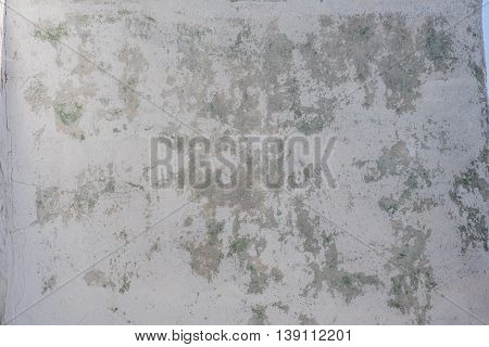 old white wall peeled spotted with cracks
