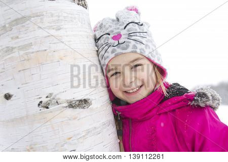A portrait of little girl in snowy park