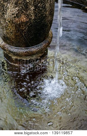 Splashed Water Drops In A Stone Standpipe