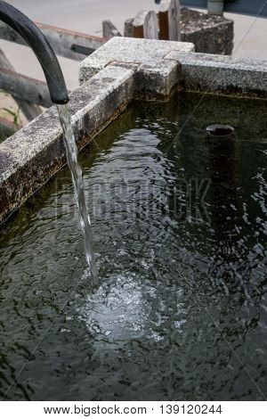 Splashed Water Drops In A Stone Standpipe