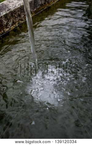 Splashed Water Drops In A Stone Standpipe