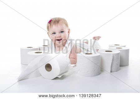 A Toddler ripping up toilet paper in studio white background