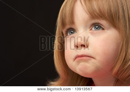 Close Up Studio Portrait Of Sad Young Girl