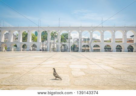 RIO DE JANEIRO BRAZIL - MARCH 06 2016: Landmark white arches of Arcos da Lapa under bright blue skies in Centro of Rio de Janeiro Brazil