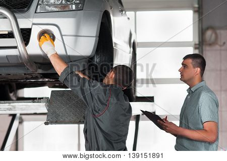 Independent car inspection at factory. Auto building plant, new model testing. Automobile production concept