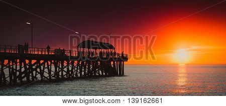 People relaxing on the Henley Beach Jetty at sunset South Australia