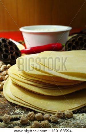 Colorful Indian food - papadum chickpea gram flour and spices on textured wooden table top