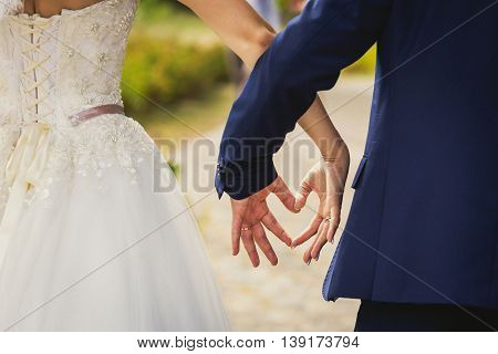 the bride and groom hands forming heart shape a symbol of love