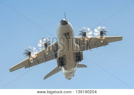 FARNBOROUGH, UK - JULY 14: Closeup of an Airbus A400M military transporter aircraft in a steep climb after take-off from Farnborough, Hampshire, UK on July 14, 2016