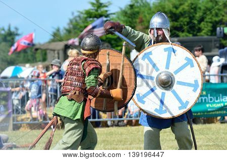 Blackwater Country Fare MALDON ESSEX UK 22 June 2014: Two Vikings fighting with sword and shields