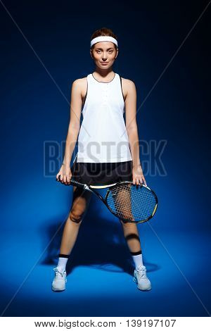 Picture of young fintess girl holding tennis racket