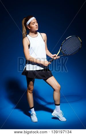 Picture of young fintess girl holding tennis racket