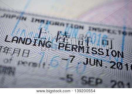 Printed passport stamp with a caption Landing permission in black ink as a part of Japanese Visa page