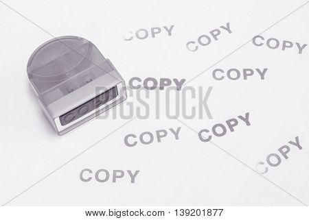 Closeup the pump rubber stamp in copy word with ink copy word on white paper textured background in black and white tone