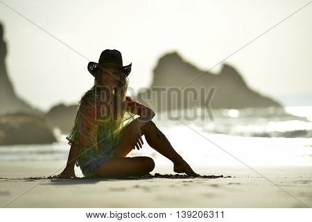 young woman relaxing on the beach in summer day