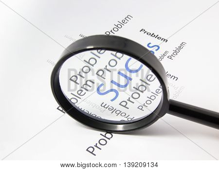Magnifier on paper focus to success word